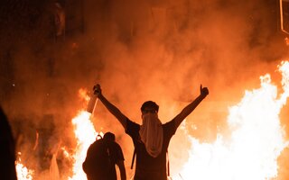 Chilean protesters in front of fires