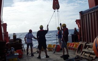 Workers on a ship ready to release buoys