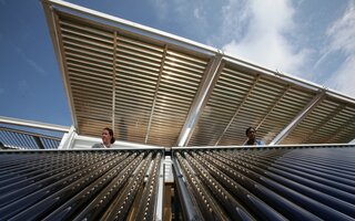 Two women inspect a solar panel 