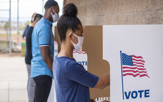 People in voting booths during US elections 
