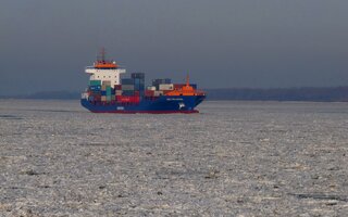 Container ship crashing through ice