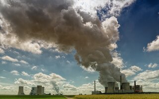 Power plant with smoking chimney