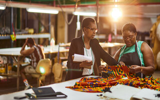 mature african business woman sewing factory