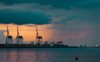 Kräne im Hafen bei Sonne, Wolken und Regen