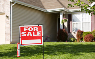 For Sale sign in front of house