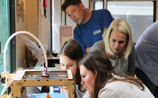 People observing 3D print - image from FryskLab