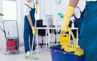 Man holding mop bucket