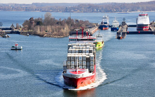Container ships leaving water gates in Kiel Holtenau to start passage through the Kiel Canal