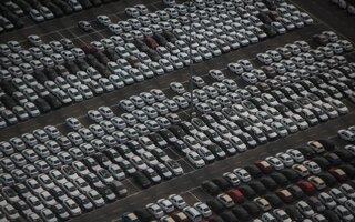 Cars in a very large parking lot, ready for shipping 