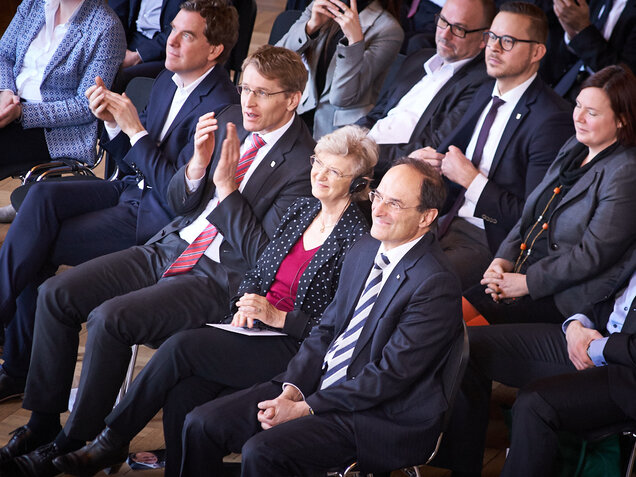 Judith und Dennis Snower neben Ministerpräsident Daniel Günther