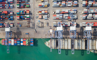 Container box loading by crane, Vessel boat in logistic Singapore port, transportation, delivery and business concept
