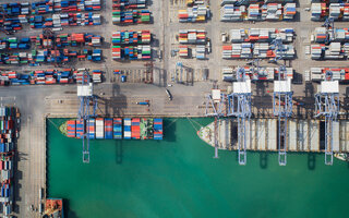 Container box loading by crane, Vessel boat in logistic Singapore port, transportation, delivery and business concept