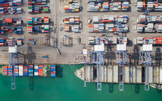 Container box loading by crane, Vessel boat in logistic Singapore port, transportation, delivery and business concept
