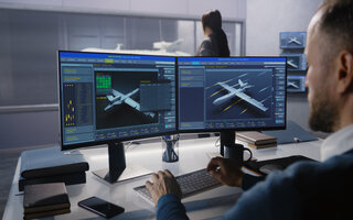Engineers check aerodynamics of new development drone in laboratory for modern modifications using wind tunnel with steam. Computer system for changing parameters