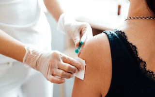 doctor vaccinating a patient against covid-19