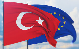 Waving European Union flag and flag of Turkey