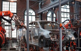 Car production line with robotic arms