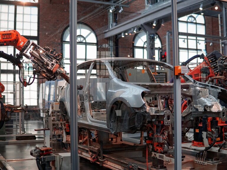 Car production line with robotic arms