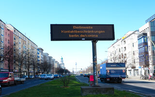 Digital traffic sign announcing contact restrictions within Berlin