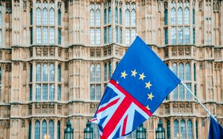 Half UK half EU flag in front of Houses of Parliament