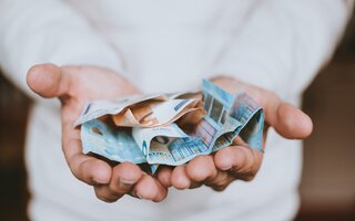 Person holding Euro banknotes